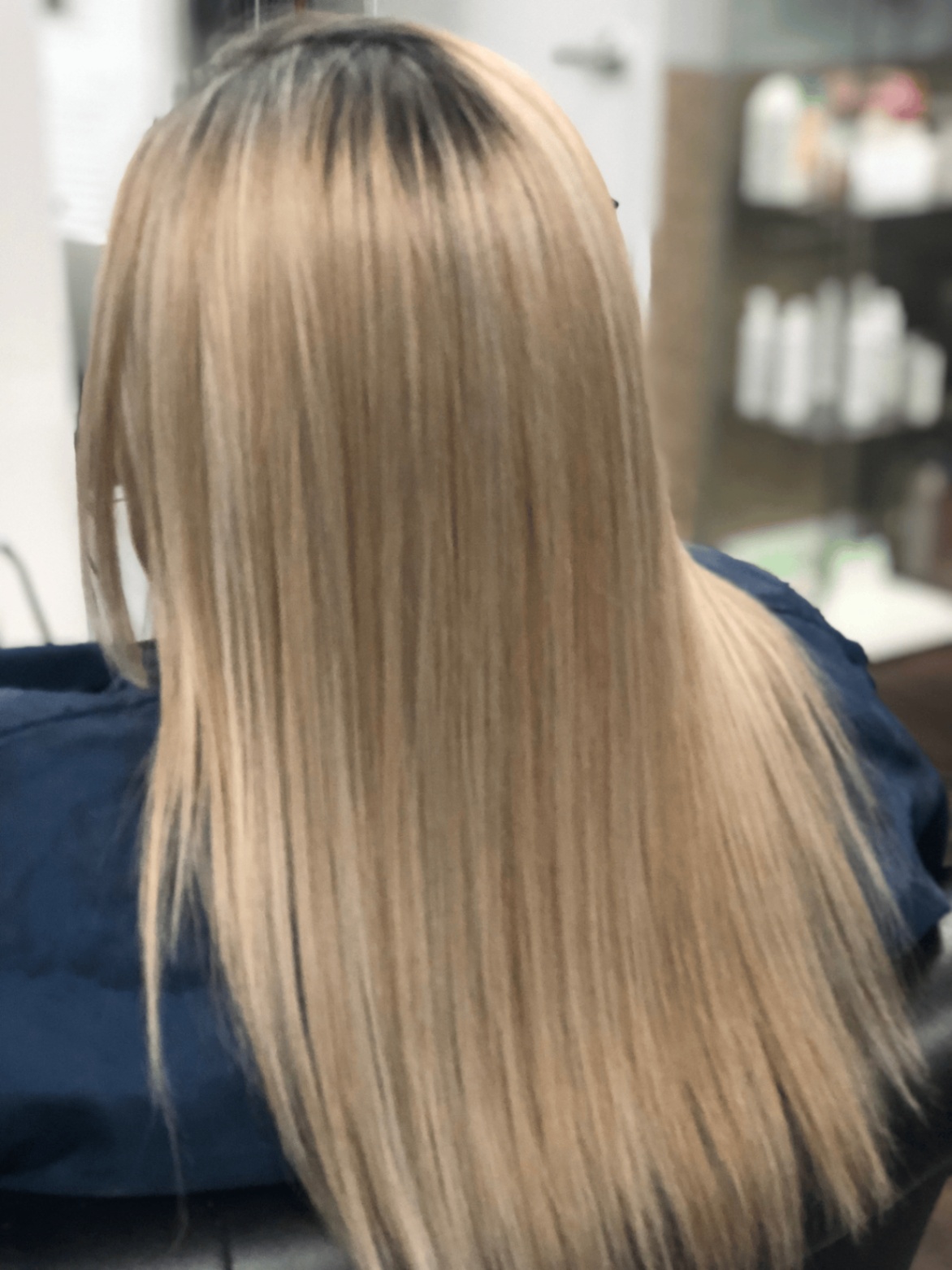 Sleek blonde hair finish at Giraldo Salon & Spa